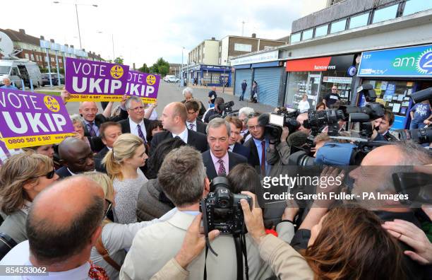 Ukip party leader Nigel Farage is surrounded by the media during a visit to South Ockendon, Essex, as his party make gains across the country...