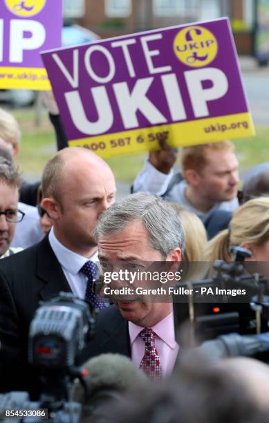 Ukip party leader Nigel Farage is surrounded by the media during a visit to South Ockendon, Essex, as his party make gains across the country...