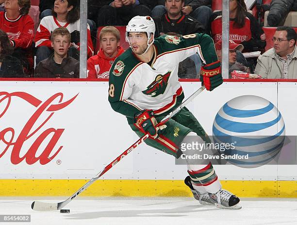 Brent Burns of the Minnesota Wild controls the puck during their NHL game against the Detroit Red Wings at Joe Louis Arena on February 12, 2009 in...