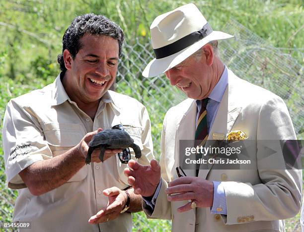 Prince Charles, Prince of Wales is presented with a tortoise whom he named William during a tour of the Darwin Research Station on Santa Cruz Island...