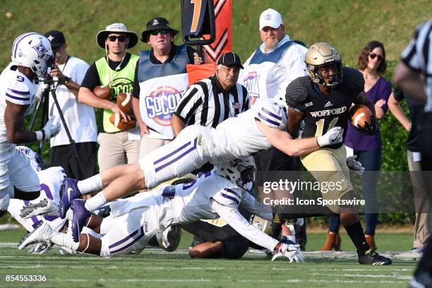 Blake Morgan halfback Wofford College Terriers attempts to break a tackle by Dillon Woodruff inside linebacker Furman University Paladins Saturday,...