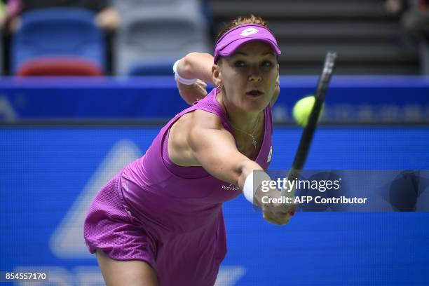 Agnieszka Radwanska of Poland hits a return against Ashleigh Barty of Australia during their third round women's singles match at the WTA Wuhan Open...
