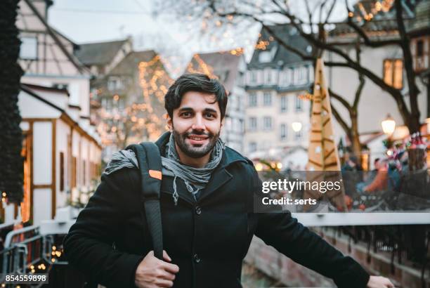 junger mann genießen weihnachten in colmar, frankreich - french and indian war stock-fotos und bilder