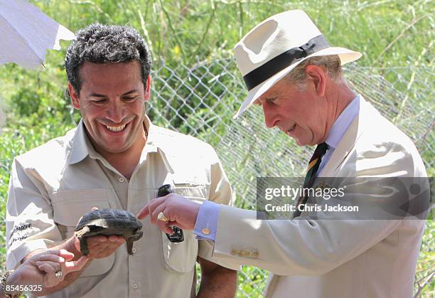 Prince Charles, Prince of Wales is presented with a tortoise whom he named William during a tour of the Darwin Research Station on Santa Cruz Island...