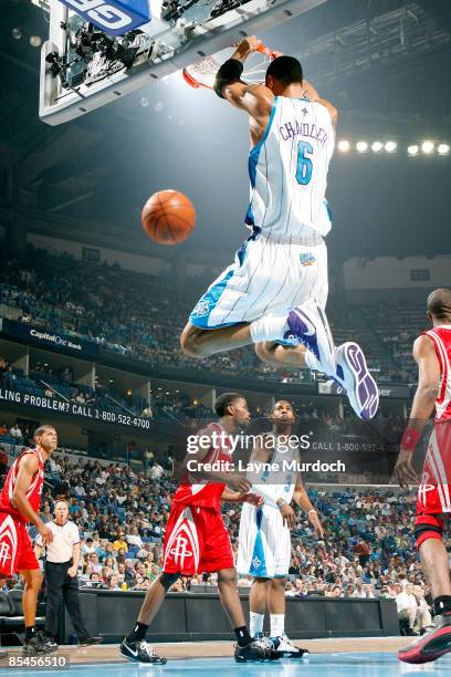 Tyson Chandler of the New Orleans Hornets dunks on Shane Battier, Aaron Brooks and Dikembe Mutombo of the Houston Rockets on March 16, 2009 at the...