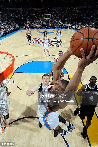 Russell Westbrook of the Oklahoma City Thunder goes up for a slam dunk against Matt Bonner and Michael Finley of the San Antonio Spurs at the Ford...