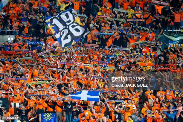 Apoel FC's fans cheer ahead of the UEFA Champions League football match between Apoel FC and Tottenham Hotspur at the GSP Stadium in the Cypriot...