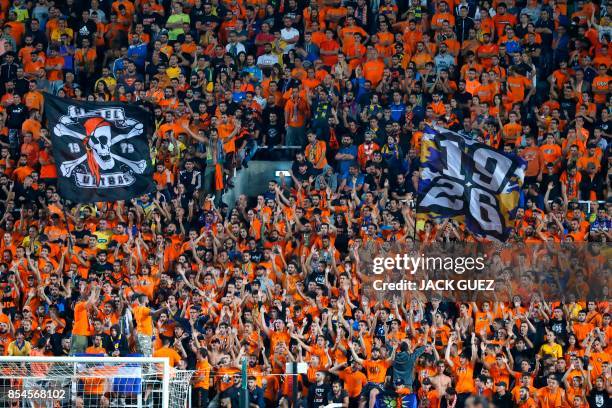 Apoel FC's fans cheer ahead of the UEFA Champions League football match between Apoel FC and Tottenham Hotspur at the GSP Stadium in the Cypriot...