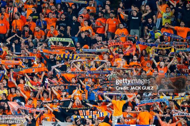 Apoel FC's fans cheer ahead of the UEFA Champions League football match between Apoel FC and Tottenham Hotspur at the GSP Stadium in the Cypriot...