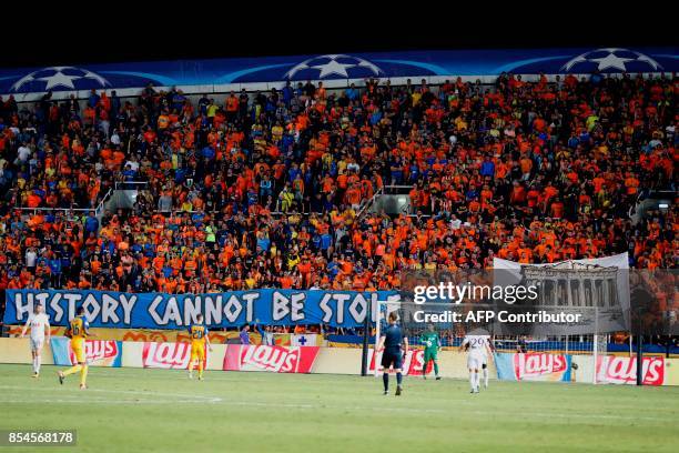 Apoel FC's fans cheer ahead of the UEFA Champions League football match between Apoel FC and Tottenham Hotspur at the GSP Stadium in the Cypriot...