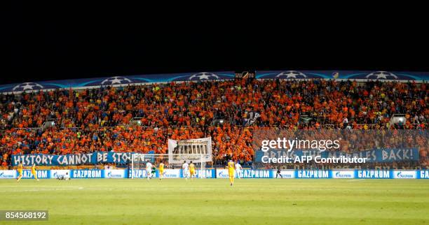 Apoel FC's fans hold banners reading in English "history cannot be stolen, bring the marbles back" during the UEFA Champions League football match...