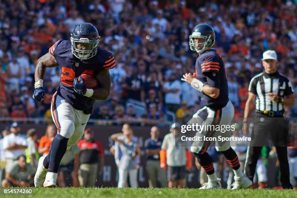 Chicago Bears quarterback Mike Glennon watches Chicago Bears running back Jordan Howard run with the footbal during an NFL football game between the...