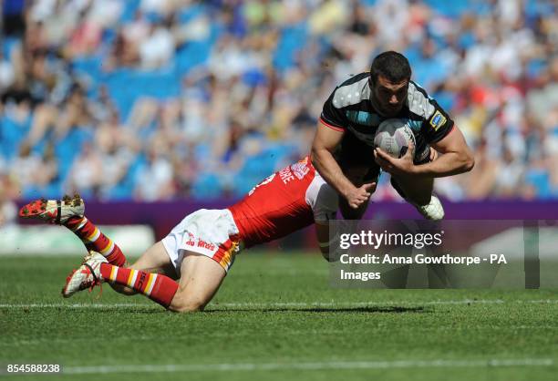 London Broncos' Maxime Herold is tackled by Catalan Dragons' Morgan Escare during the First Utility Super League Magic Weekend match at the Etihad...