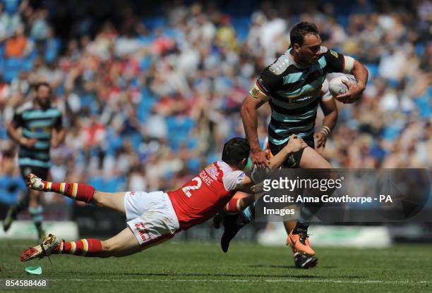 London Broncos' Nick Slyney is tackled by Catalan Dragons' Morgan Escare during the First Utility Super League Magic Weekend match at the Etihad...