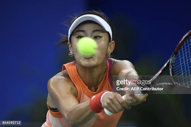 Wang Qiang of China hits a return against Karolina Pliskova of Czech Repubic during their third round women's singles match at the WTA Wuhan Open...