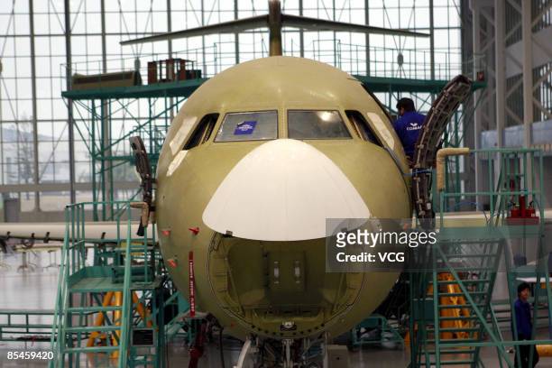 China's first domestically designed and produced passenger jet, the ARJ21, is seen on a production line at a Shanghai Aircraft Manufacturing factory...