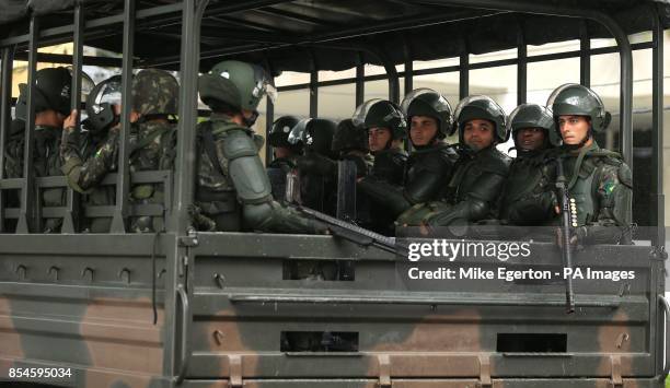 Armed Soldiers follow the England team bus as it arrives at Urca Military Training Ground, Rio de Janeiro, Brazil.