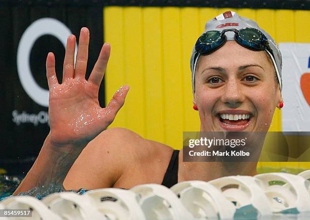 Stephanie Rice of St Peters Western waves to the crowd after winning the women's 200 metre individual medley final during day one of the 2009...