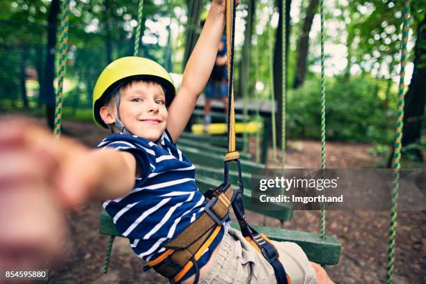 little boys having fun during in ropes course  adventure park - extreme sports kids stock pictures, royalty-free photos & images