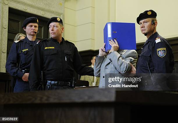 In this handout picture Josef Fritzl covers his face as he arrives at the second day of his trial at the country court of St. Poelten on March 17,...