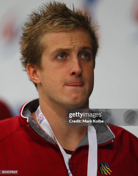 Nick D'Arcy of Queensland Acedemy of Sport leaves the medal ceremony after winning the Men's 200 metres butterfly final during day one of the 2009...