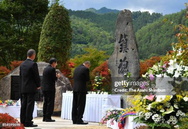 Bereaved families and others unveil a monument to console the souls of victims of Mount Ontake's eruption three years ago on September 27, 2017 in...