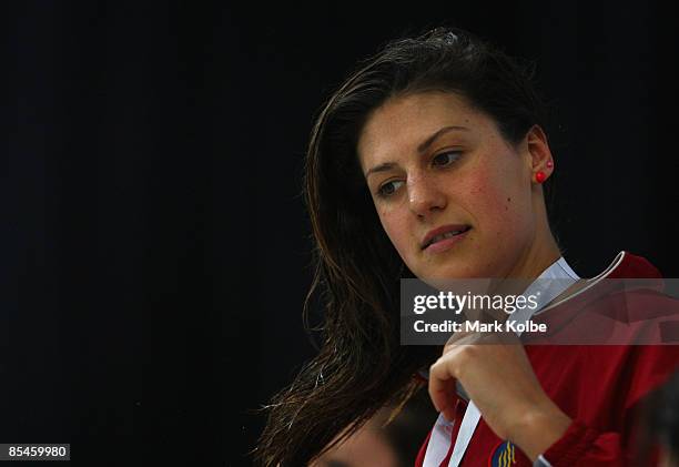 Stephanie Rice of St Peters Western adjusts her hair during the medal ceremony for the Women's 200 metre individual medley final during day one of...