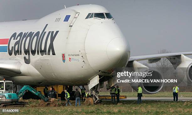 Boeing 747 cargo belonging to Cargolux of Luxembourg is towed from the side of the taxiway after losing its nosewheel at Maastricht's Aachen Airport...