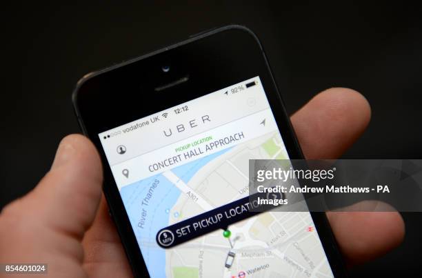 The Uber app being used on an Apple iPhone 5, as a row has flared over the introduction of the app which allows customers to book and track vehicles.