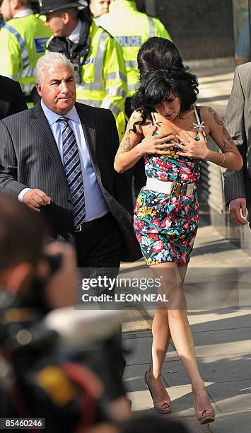 British singer Amy Winehouse arrives with her father Mitch, at Westminster Magistrates Court, in west London, on March 17, 2009. Winehouse appears...