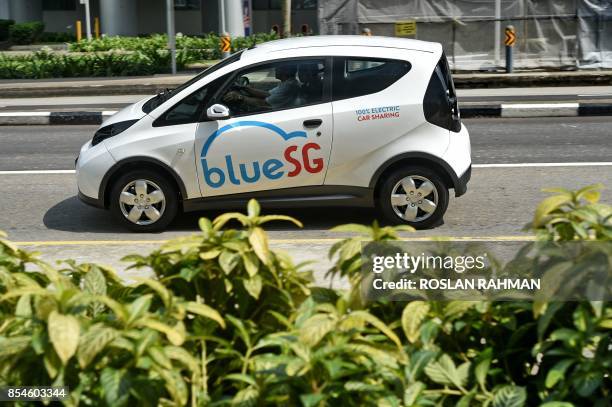 An electric Bluecar is taken for a road test drive during the launch of BlueSG office, a subsidiary of France's Bollore Group, in Singapore on...