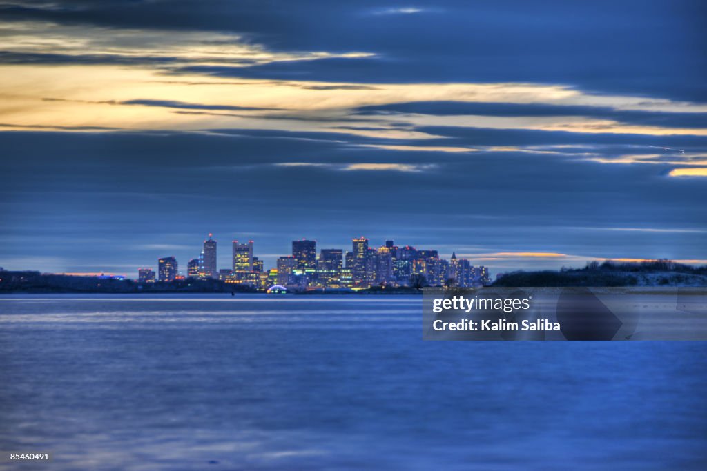 Sunset Over Boston & Atlantic Ocean From a Beach