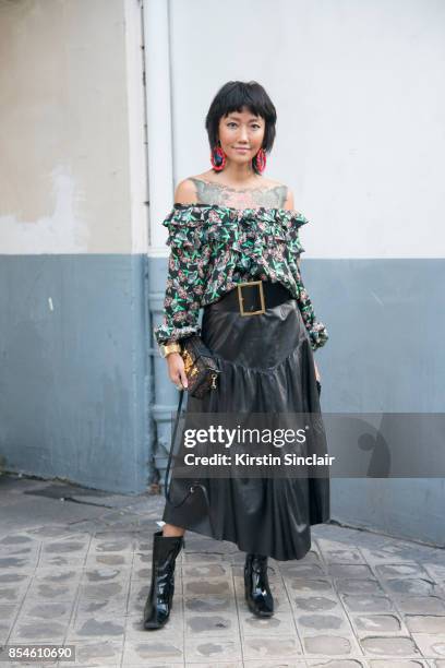 Chinese fashion blogger Carrie Lee wears Dior skirt and top Louis Vuitton bag, Balenciaga shoes and earrings she made herself day 1 of Paris Womens...
