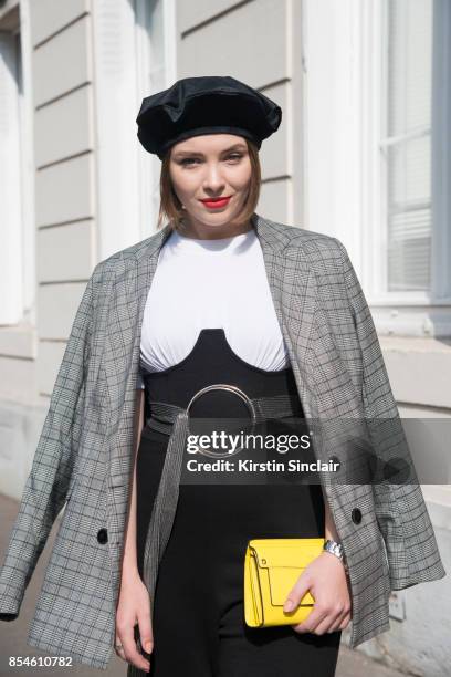 Russian fashion blogger and producer Lisaveta wears a Stradivarius jacket, ASOS belt and jumpsuit, Furla bag and Zara hat day 1 of Paris Womens...