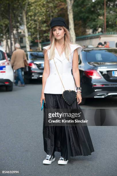 Fashion blogger Charlotte Groeneveld wears a Dior top, skirt, bag, hat and shoes day 1 of Paris Womens Fashion Week Spring/Summer 2018, on September...