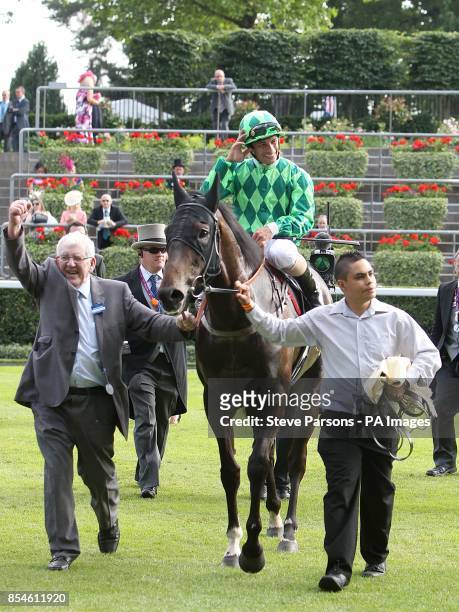 Jockey Silvestre de Souza takes the applause as he is lead into the winners enclosure on board Louis The Pious after victory in the Buckingham Palace...
