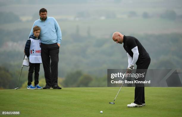 Former footballer Steve Stone putts as former cricketer Steve Harmison watches during the pro am ahead of the British Masters at Close House Golf...