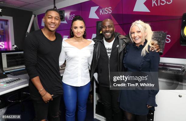 Demi Lovato poses for a photo with Melvin Odoom, Rickie Haywood Williams and Charlie Hedges during a visit at Kiss FM Studio's on September 27, 2017...