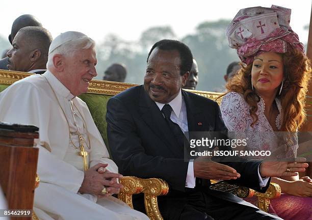 Pope Benedict XVI speaks to Cameroonian President Paul Biya and his wife Chantal on March 17, 2009 on arrival at the airport in Yaounde. Pope...