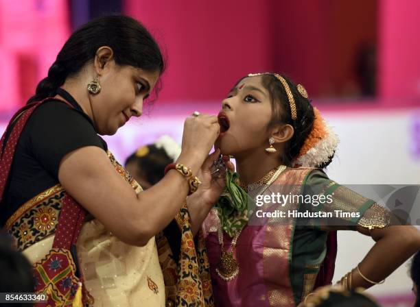 Mother makes her daughter ready on the occasion of Durga Puja at the Pandal on Maha Saptami Day, at Arambagh Durga Puja Samiti, Panchkuian road, on...