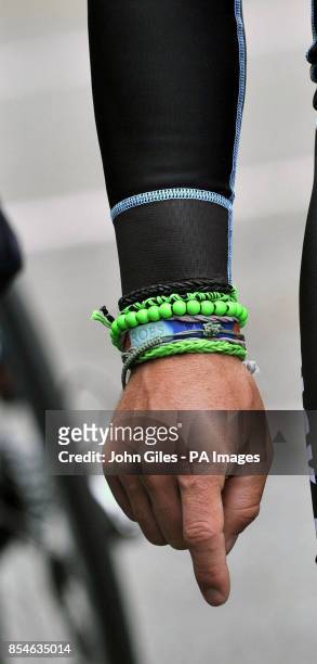 Omega Pharma - Quick-Step's Mark Cavendish wearing a green beaded bracelet as he waits to start his training session on the Tour de France route...