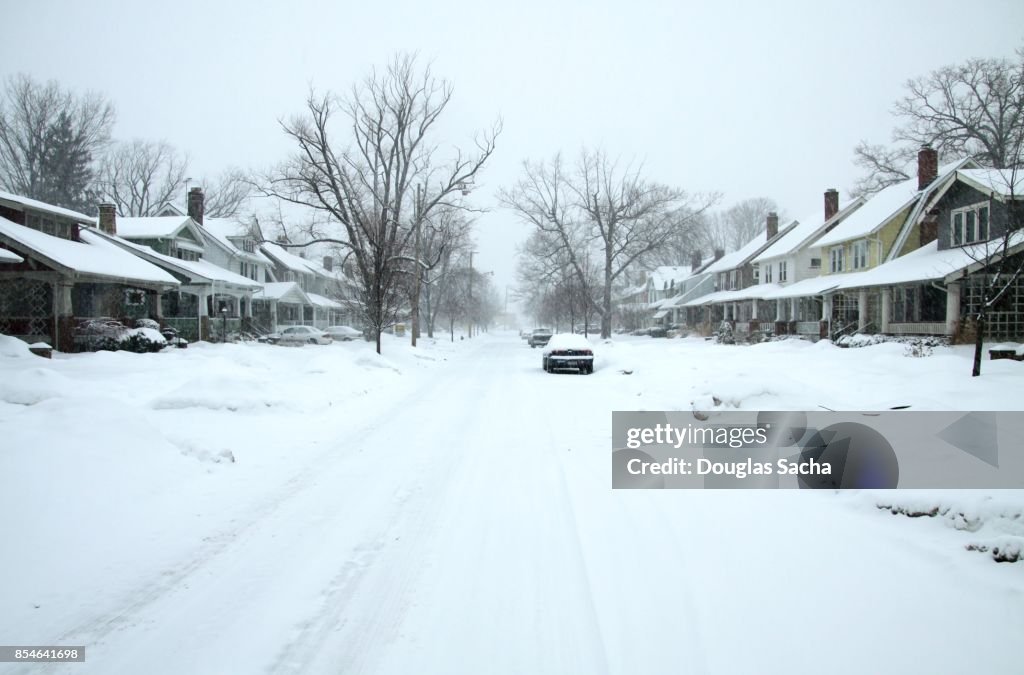Residential street covered in a blanket of snow after the storm
