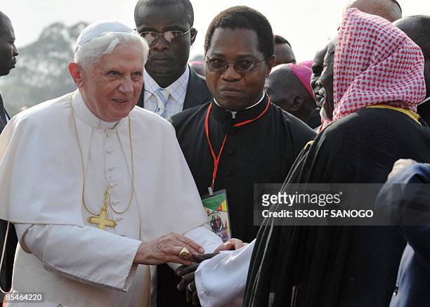 Pope Benedict XVI greets an imam on arrival at the airport in Yaounde on March 17, 2009. Pope Benedict XVI brought the "Christian message of hope" to...