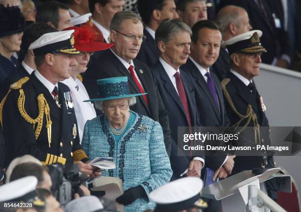 Queen Elizabeth II prepares to deliver a speech while the Duke of Edinburgh, Prime Minister David Cameron and Defence Secretary Philip Hammond look...