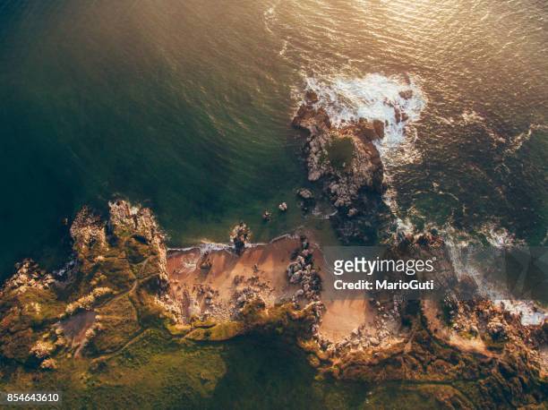 aerial view of small rocky beach - ocean cliff stock pictures, royalty-free photos & images