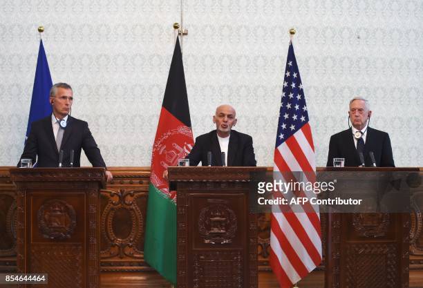 Afghan President Ashraf Ghani speaks next to US Defense Secretary Jim Mattis and NATO chief Jens Stoltenberg during a press conference at the...
