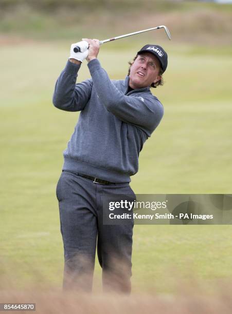 Defending Champion Phil Mickelson keeps an eye on his approach at the 1st hole during day one of the Aberdeen Asset Management Scottish Open at Royal...
