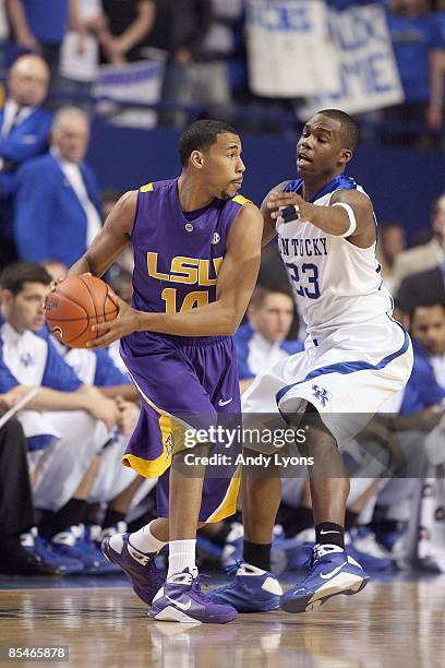 Garrett Temple of the LSU Tigers looks to pass the ball against Jodie Meeks of the Kentucky Wildcats during the SEC game at Rupp Arena on February...