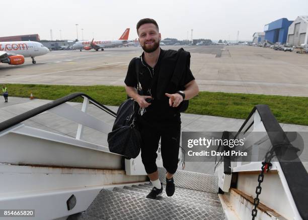 Shkodran Mustafi of Arsenal boards the plane at Luton Airport on September 27, 2017 in Luton, England.