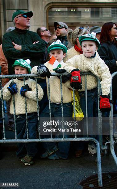 John, Robert, and Michael Scheurer watch the 248th annual St. Patrick's Day parade March 17, 2009 in New York City. The parade honors the patron...